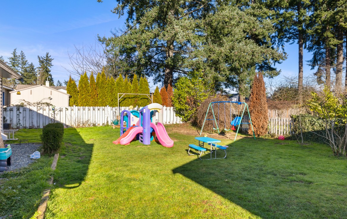 Full view of the backyard with play equipment.