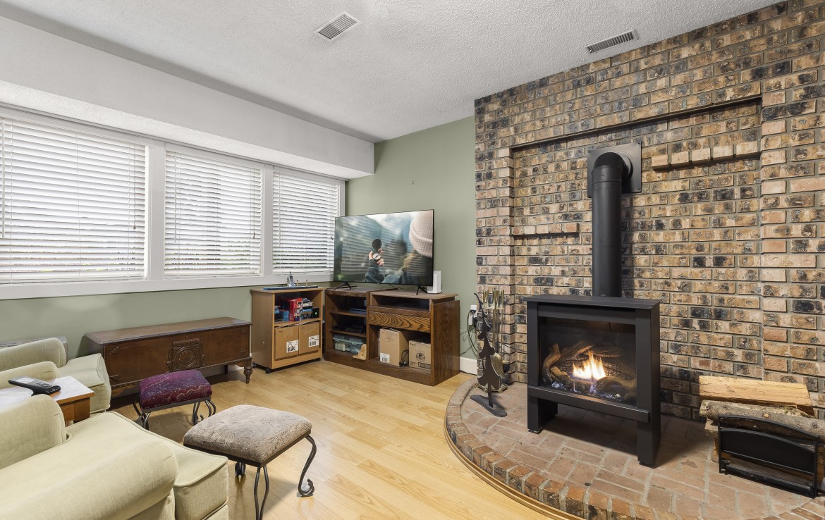 View of the gas fireplace with full brick in downstairs family room.
