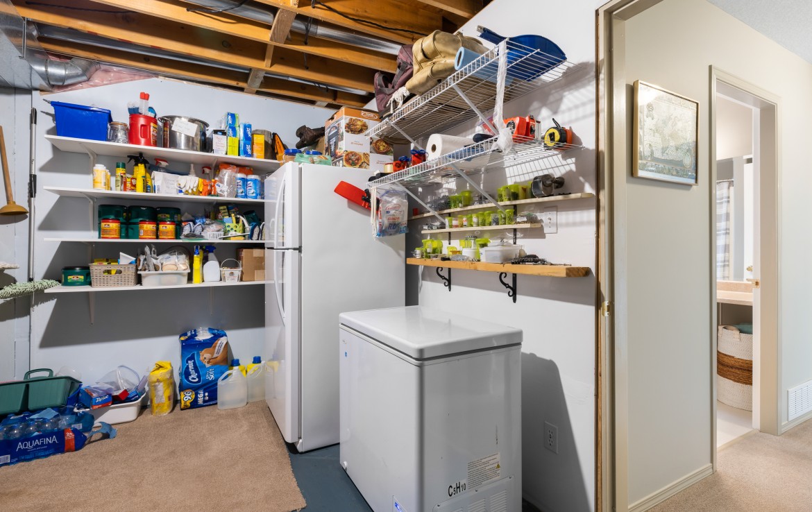 Utility and storage room with extra fridge and freezer. A lot of extra storage.