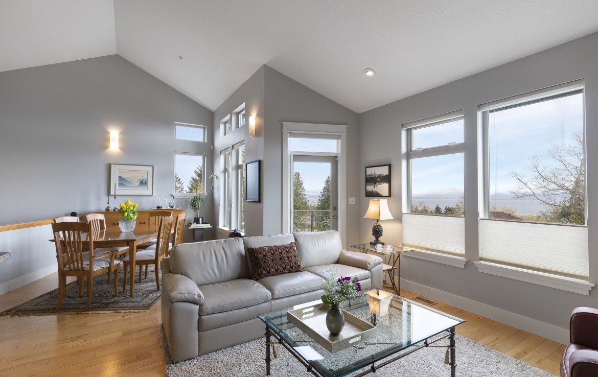 Sitting space with lots of windows to ocean and mountain view of North Nanaimo Townhouse