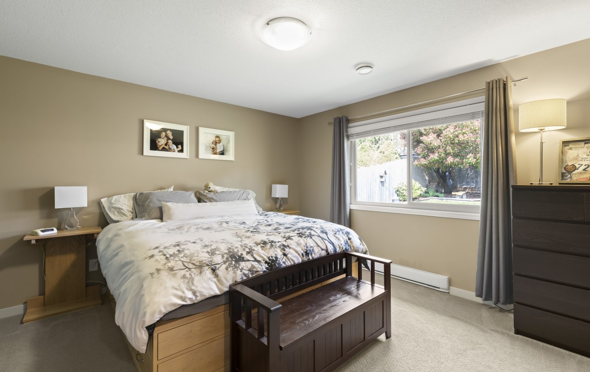 Master bedroom with large window to the backyard of Nadely, Nanaimo, BC